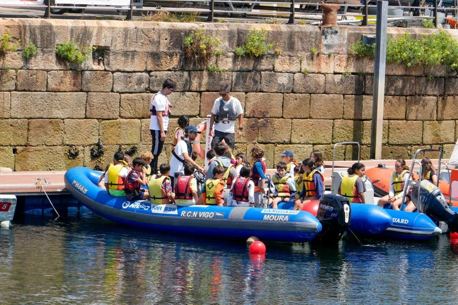Niños y monitores en el Náutico de Vigo encima de una zodiac a punto de comenzar la jornada de actividades náuticas