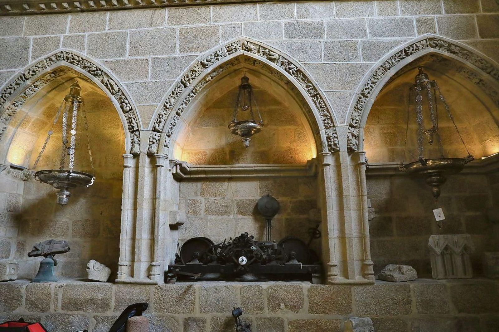 Lámparas y reloj.  Lás lámparas que adornaban la Catedral -todas lámparas votivas y de plata- iluminaron el edificio hasta la llegada de la luz eléctrica. Abajo, el mecanismo que se utilizaba antiguamente para el cambio manual de la hora, el cual está de aniversario pues cumple 140 años.