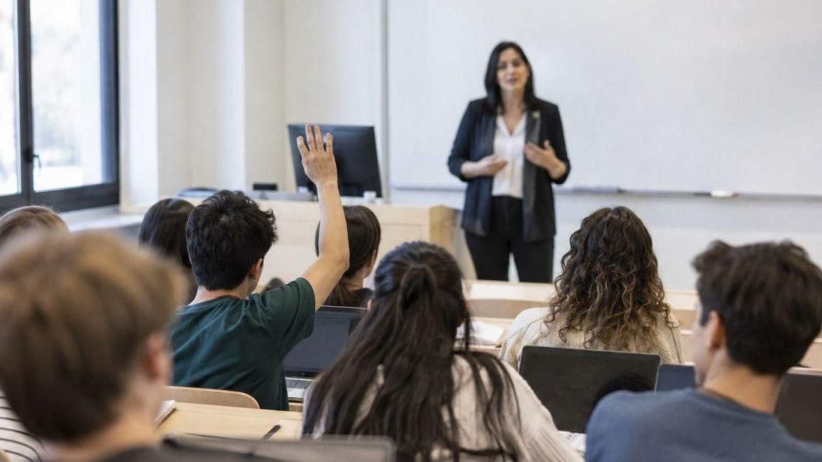 Un grupo de estudiantes y su profesora, durante una clase.