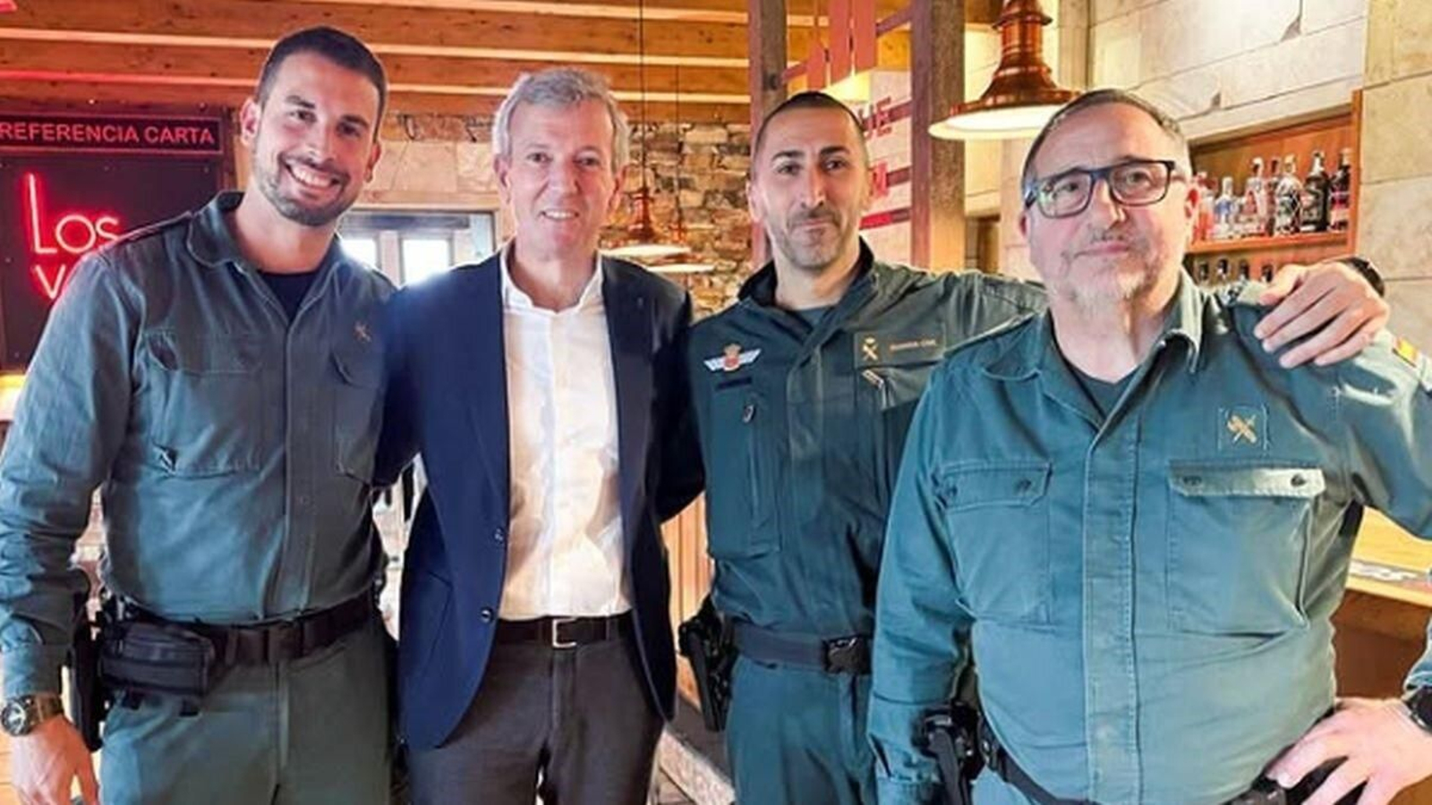 Tres guardia civiles haciéndose una foto con el presidente de la Xunta, Alfonso Rueda, en su camino a Madrid para Fitur 2025.