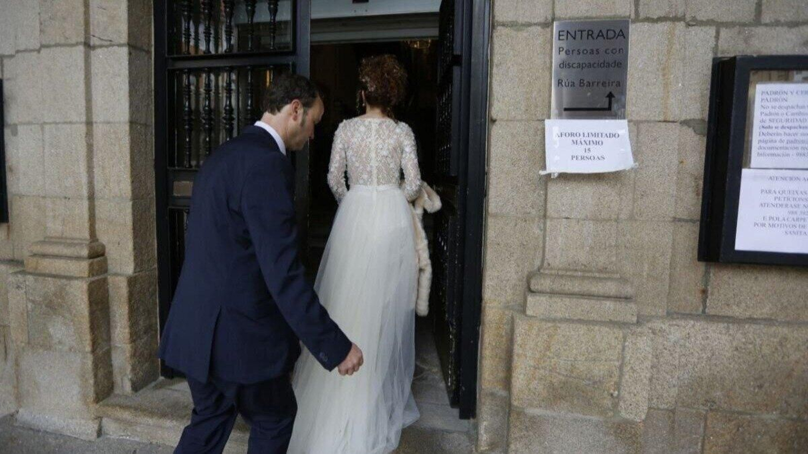 Una pareja entrando por la puerta del Concello de Ourense para formalizar su matrimonio.