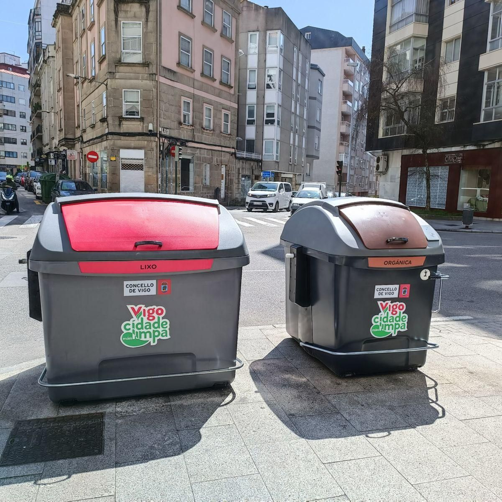 Dos contenedores de Vigo, uno (rojo) para residuos generales y otro (marrón) para residuos orgánicos