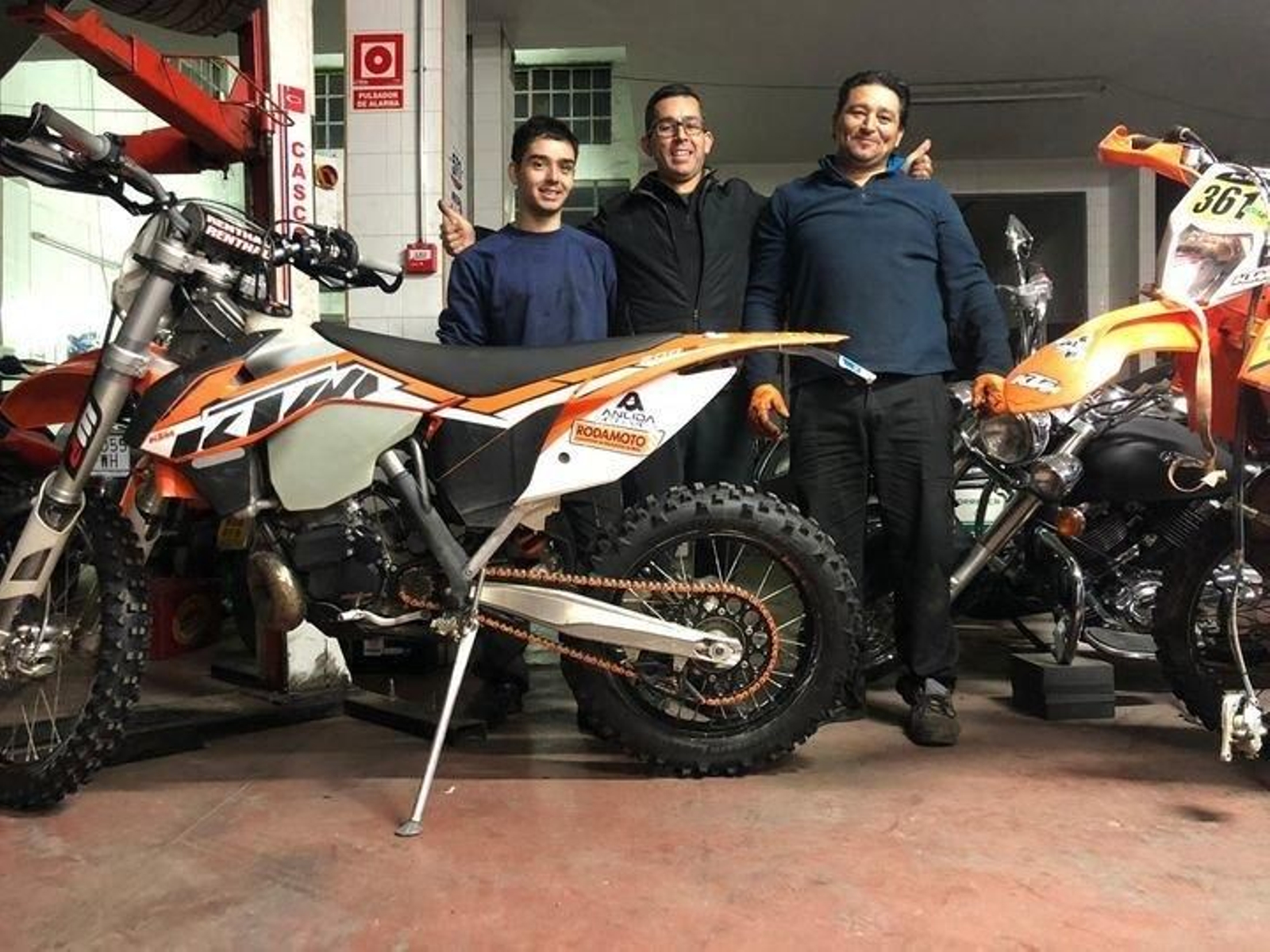 En el centro de la imagen, Ramiro Folla, con los mecánicos de su equipo, David y Lolo.