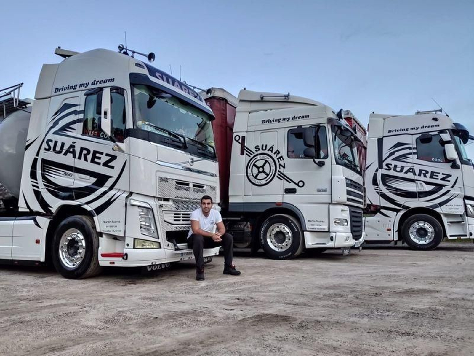Martín Suárez, con dos de sus camiones.