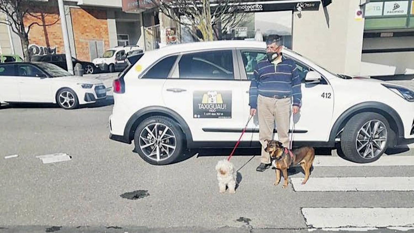 Benni Veloso con sus perros y su taxi para mascotas.