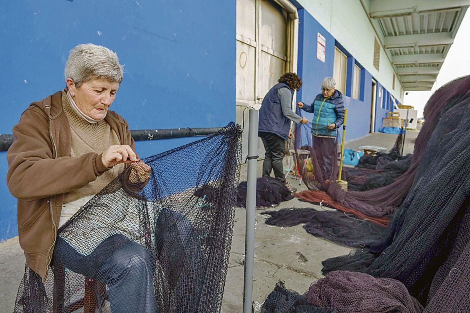 Las rederas del Berbés, cosiendo esta semana.
