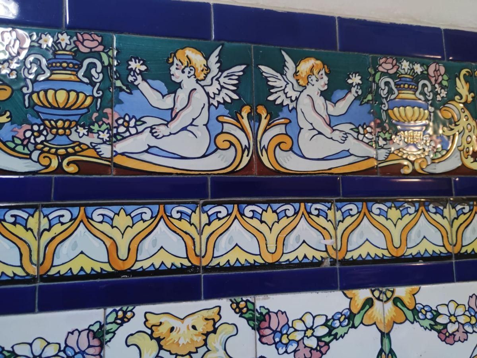 Portal de la calle Galicia con angelitos. No son frecuentes las figuras humanas.