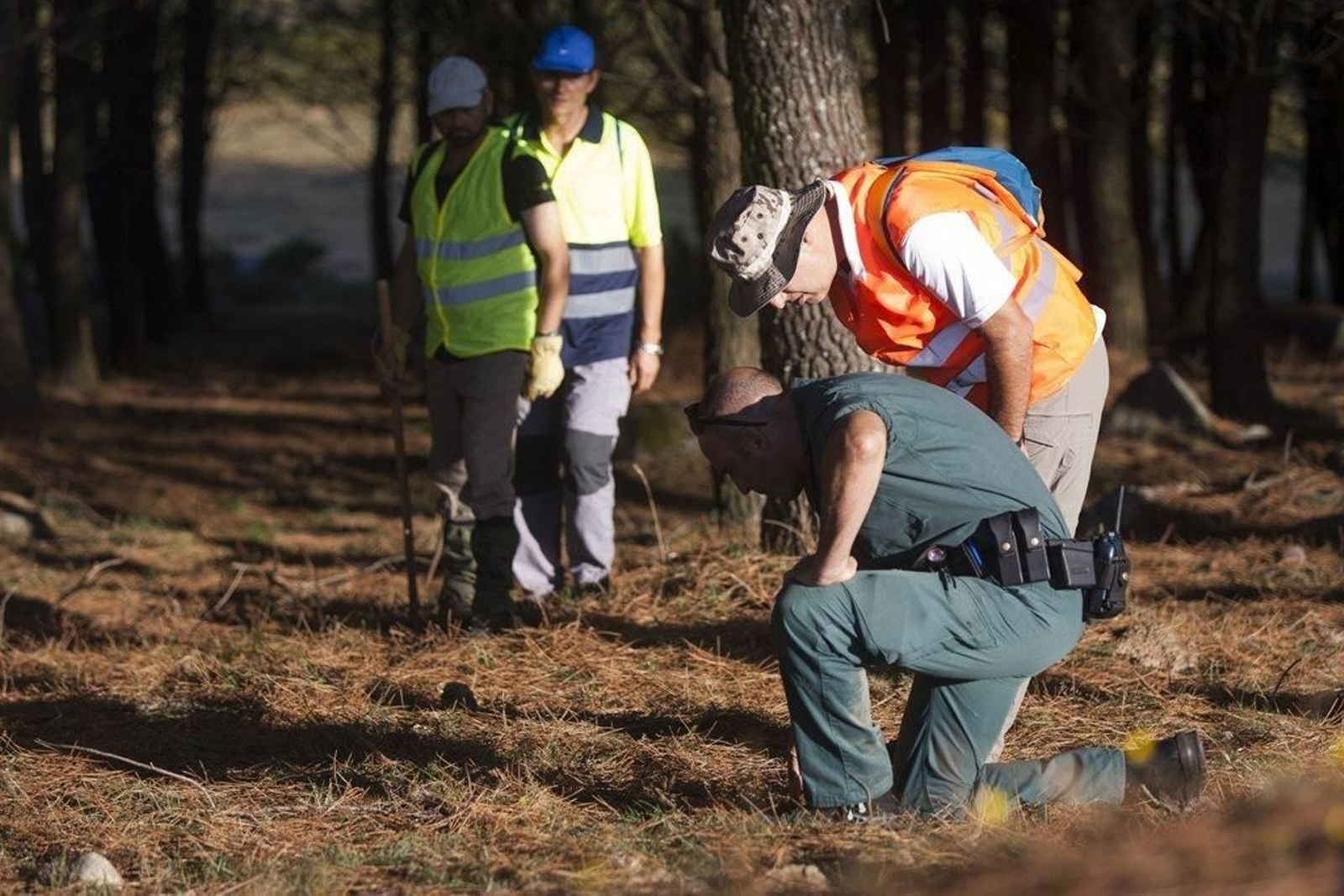 Un agente de la Guardia Civil y tres voluntarios, buscando pistas en A Pobra do Caramiñal.
