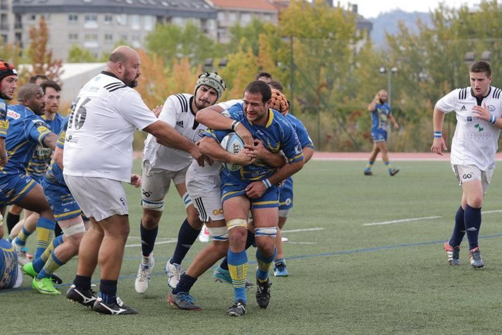 Abraham recibe  el placaje de varios rivales del Real Oviedo. (I. DACAL)