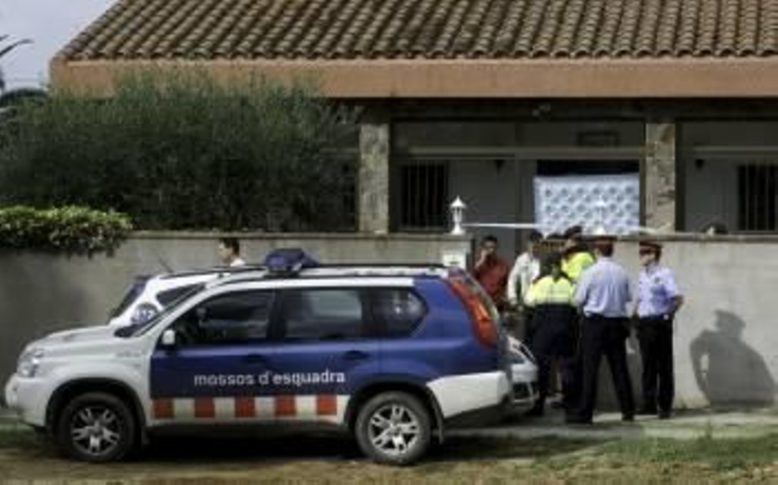 Agentes de los Mossos, en las puertas de la vivienda.