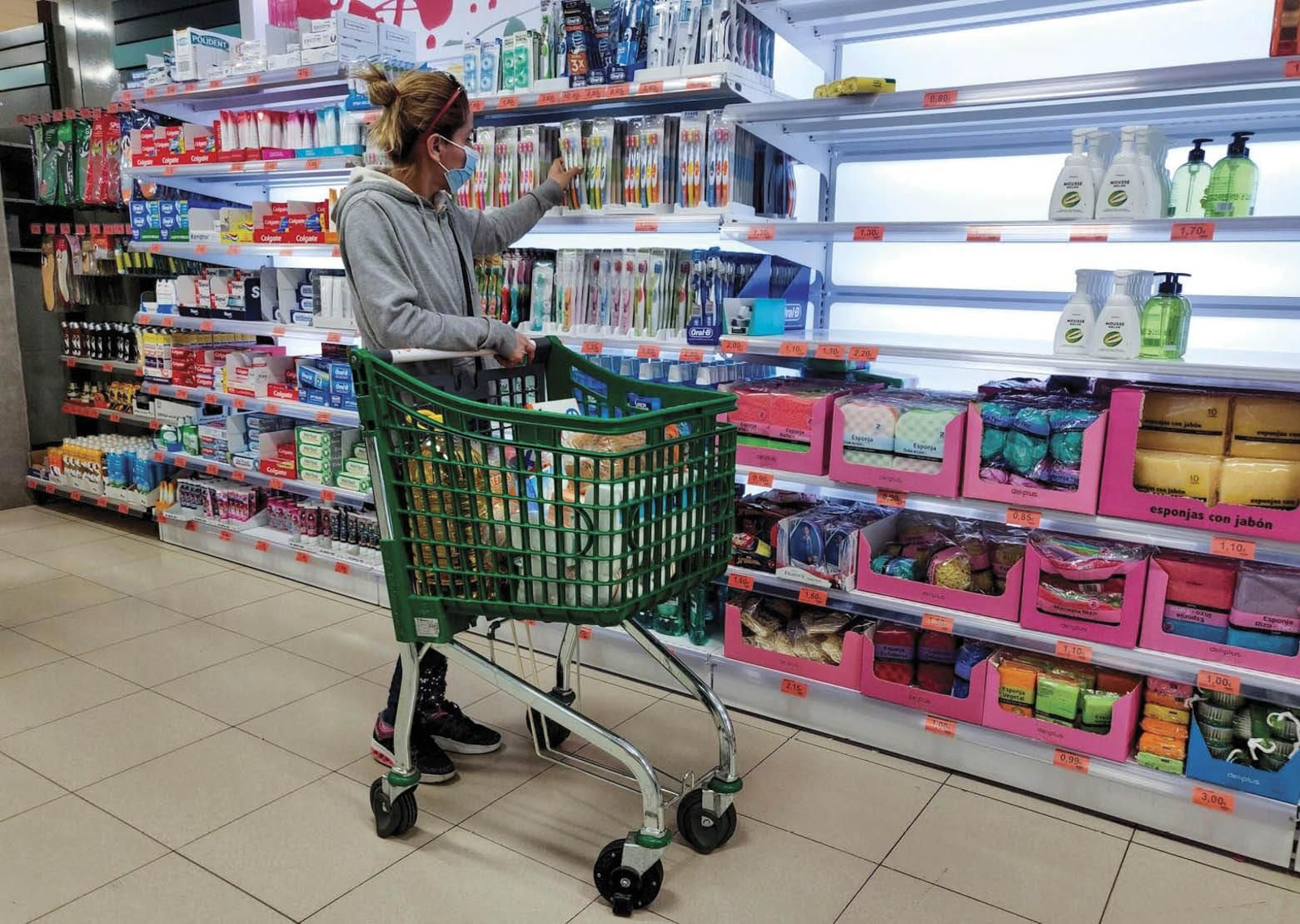 Una mujer compara productos en uno de los expositores de un supermercado.