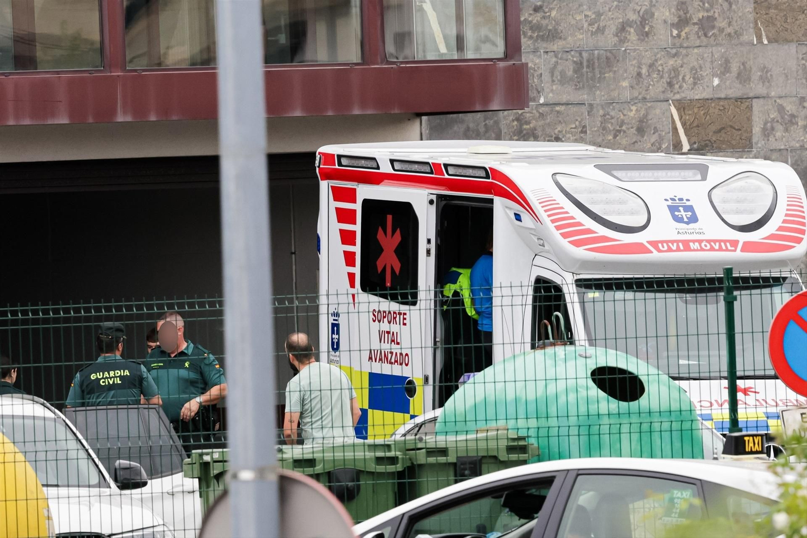 Varios agentes de la Guardia Cilvil y una ambulancia UVI móvil, en la puerta de entrada del cuartel de la Guardia Civil en Llanes.