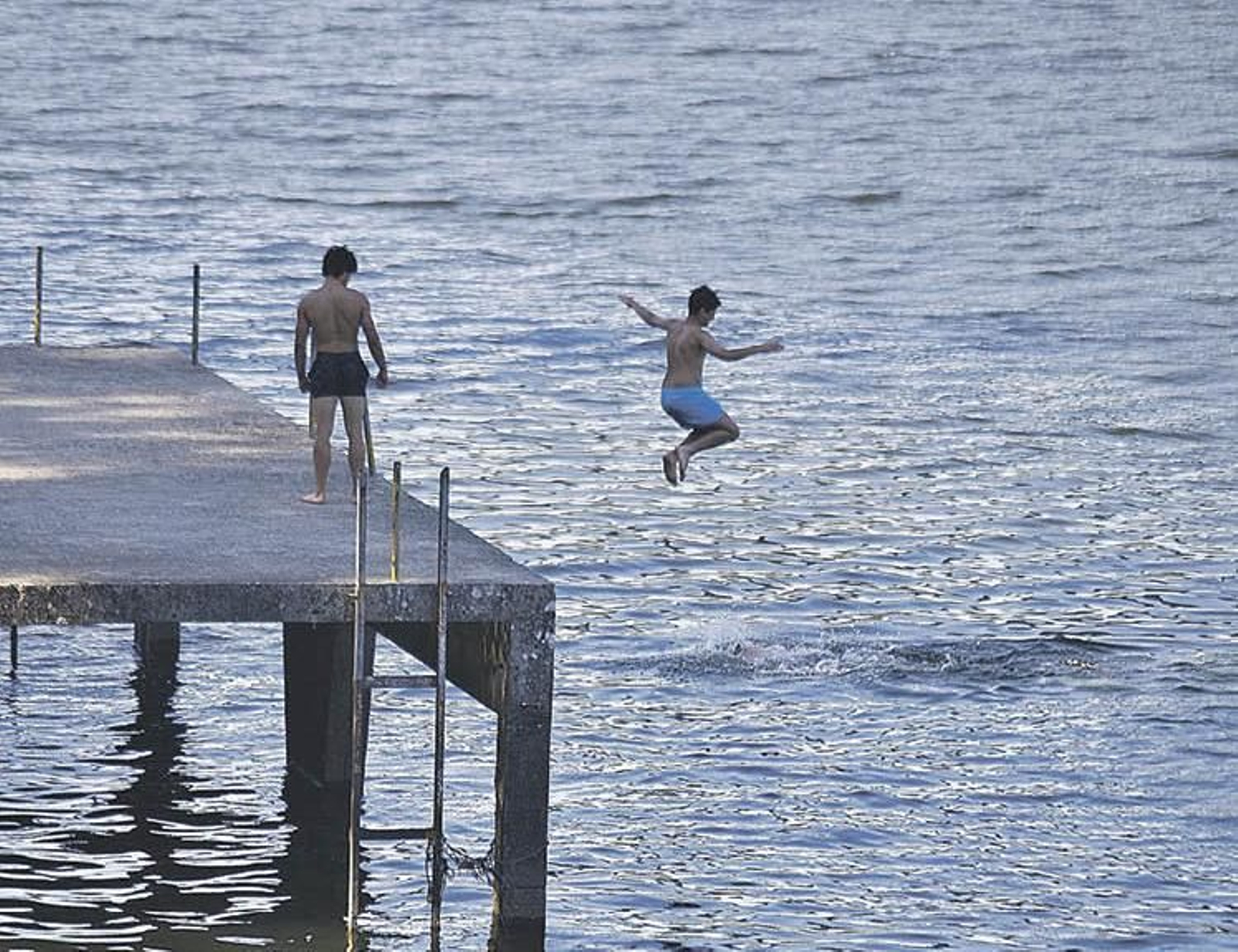 Dos jóvenes se bañan en el embalse de Velle.