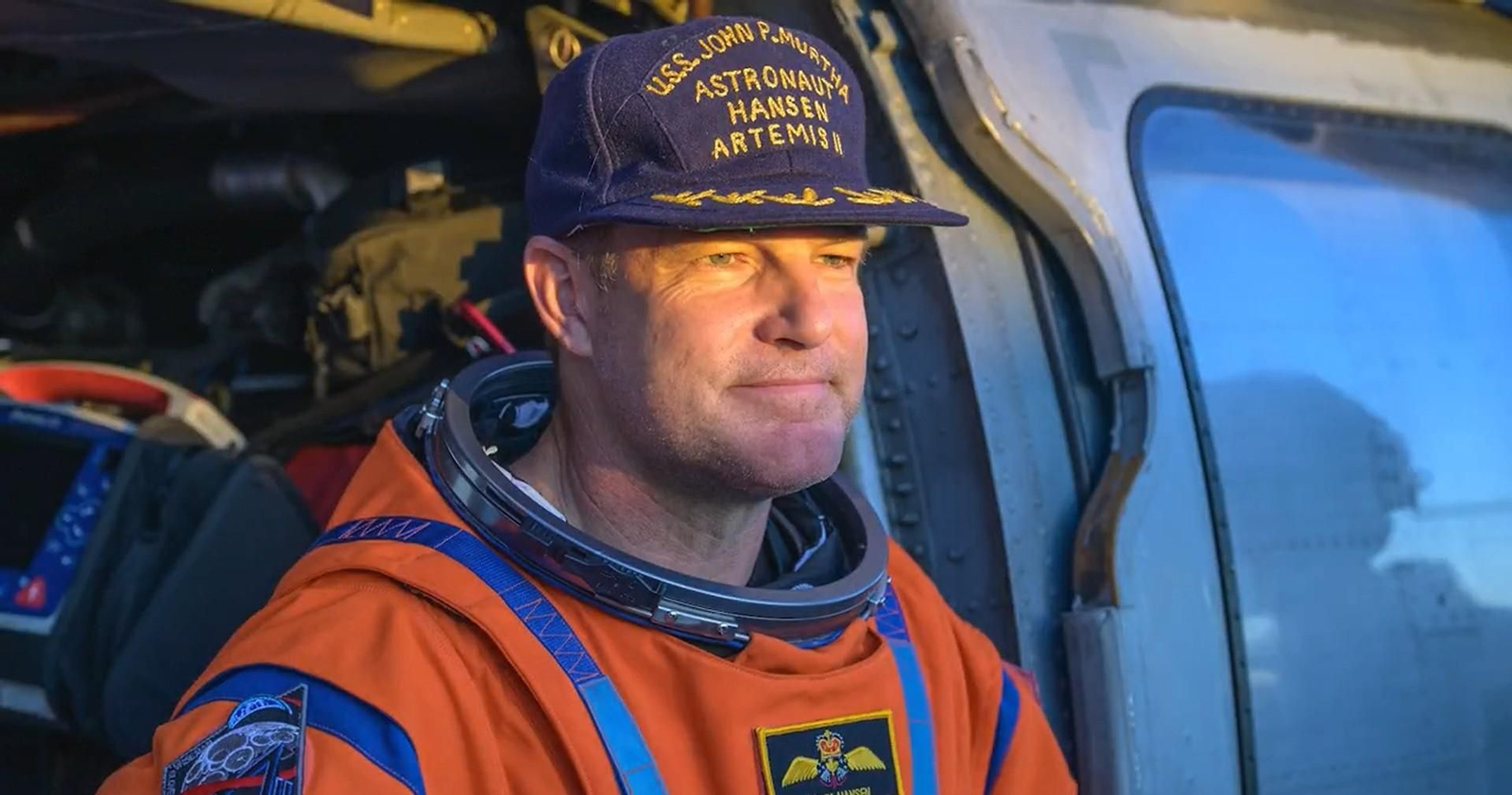 Reid Wiseman es asistido por personal de la Marina a bordo del helicóptero