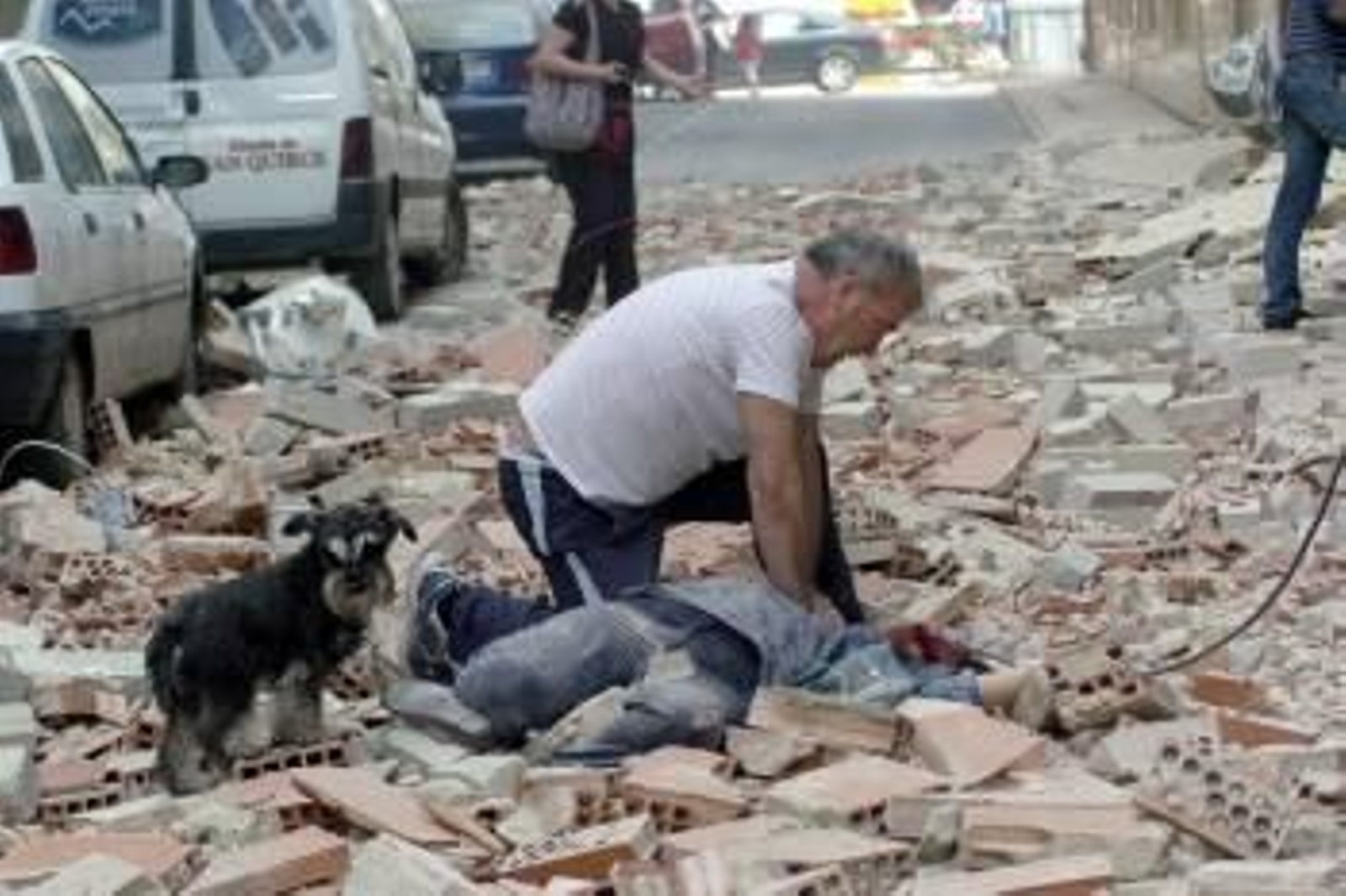 Un hombre en la calle Galicia de Lorca, junto a uno de los fallecidos a causa del terremoto de 5,2 grados que ha sacudido la región de Murcia y que ha provocado diez fallecidos, según ha informado la Comunidad Autónoma de Murcia