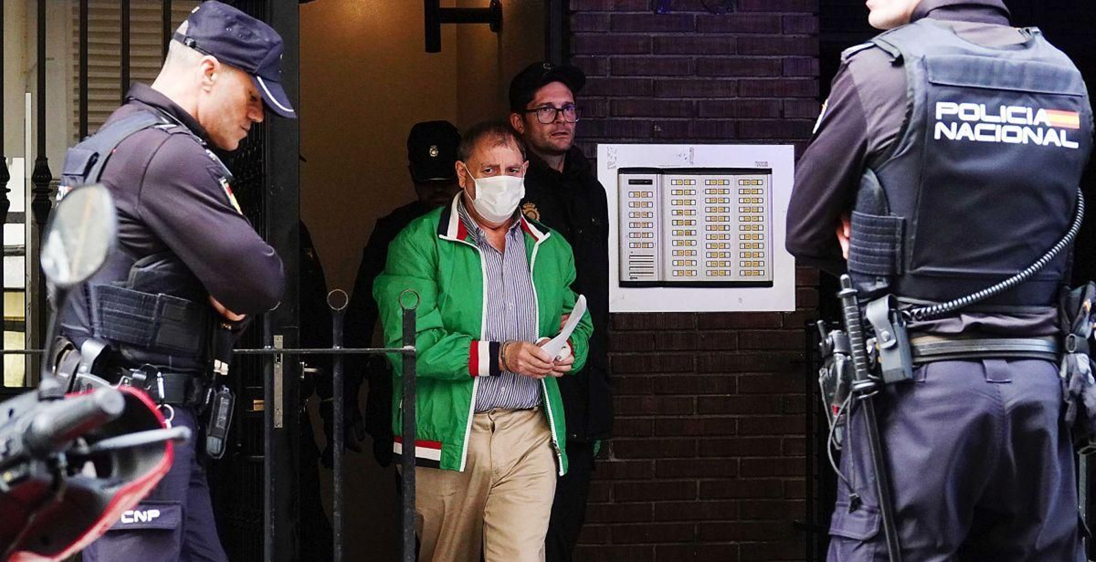 El detenido Pablo P., ayer, a la salida de un registro en el edificio de la calle Zamora donde ocurrió el crimen, custodiado por la Policía.