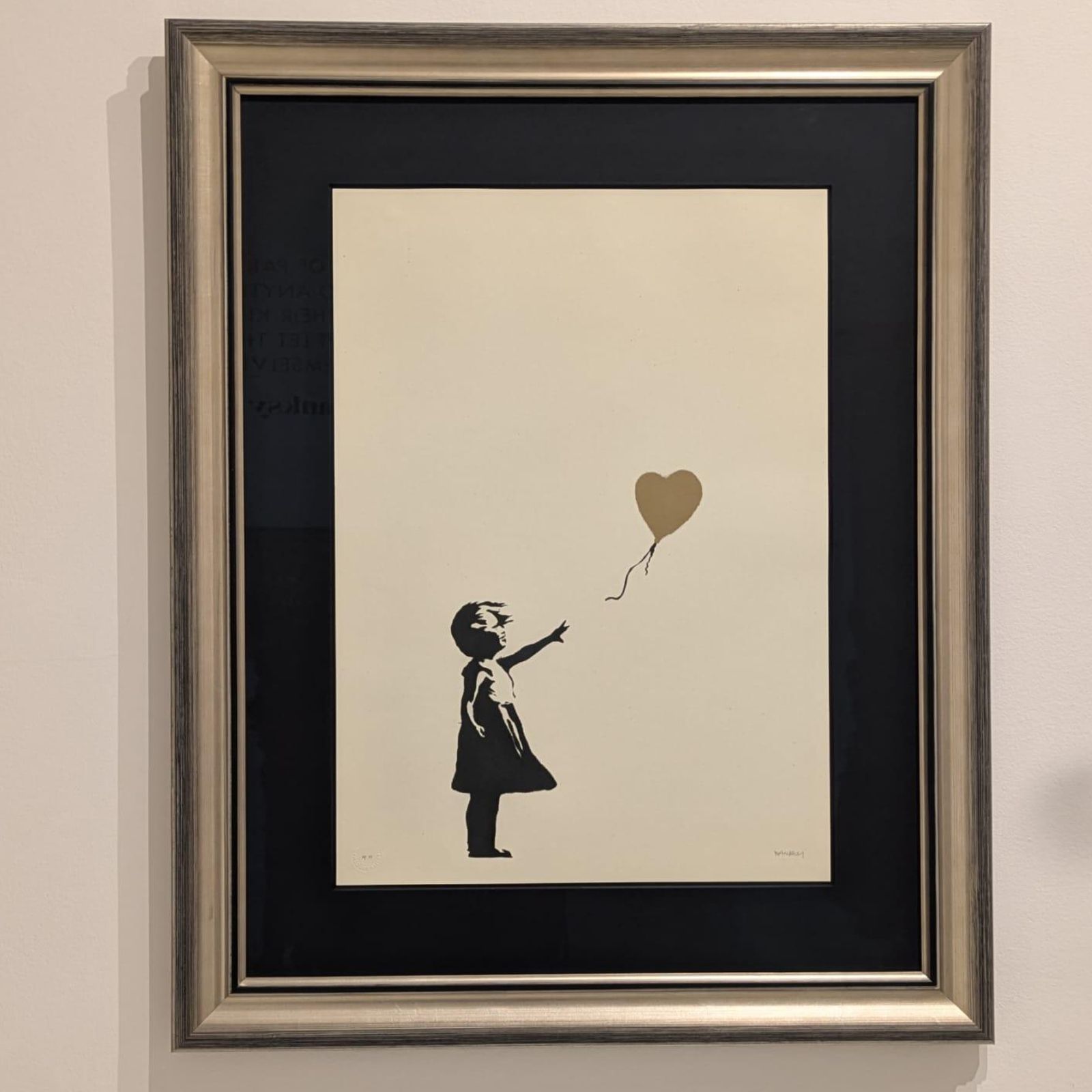 Esta imagen muestra la obra de arte Niña con globo (Girl with Balloon) del artista Banksy, famosa por representar la fragilidad de la esperanza y la inocencia.  Banksy
