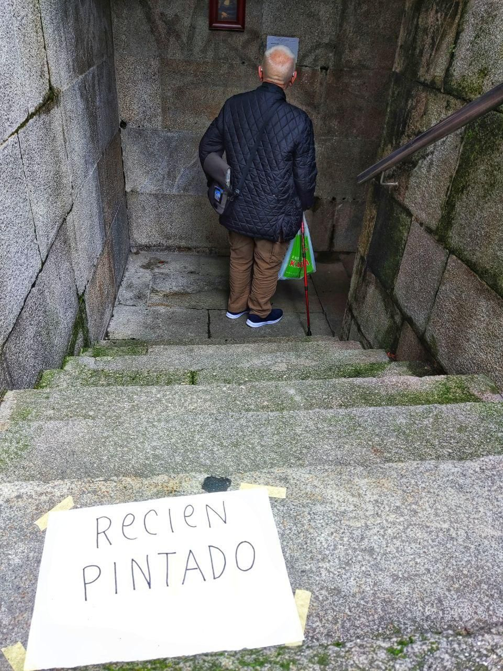 Cartel de "recién pintado" antes de llegar a la pared en la que se ha colocado la Mona Lisa. // Vicente Alonso