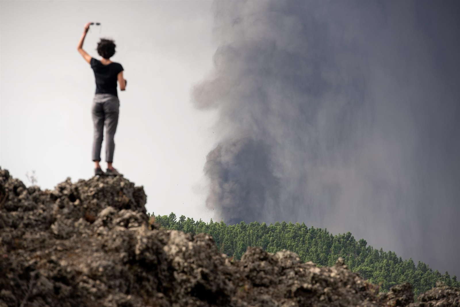 Una mujer contempla el humo procedente del volcán. (EFE)
