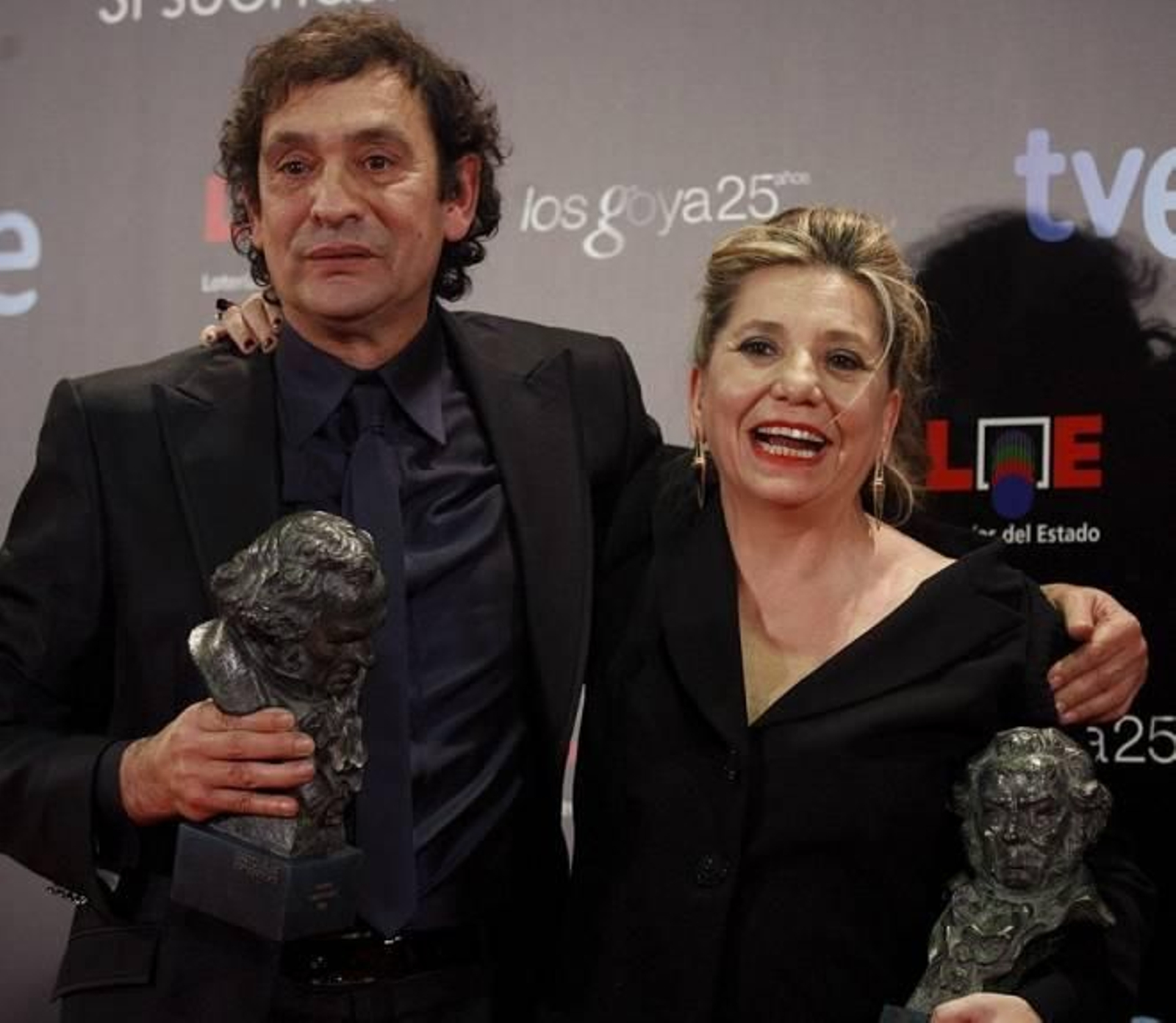 El director de cine Agustí Villaronga y la productora Isona Pasolla posan con los Goyas al 'Mejor director' y 'Mejor película'.
