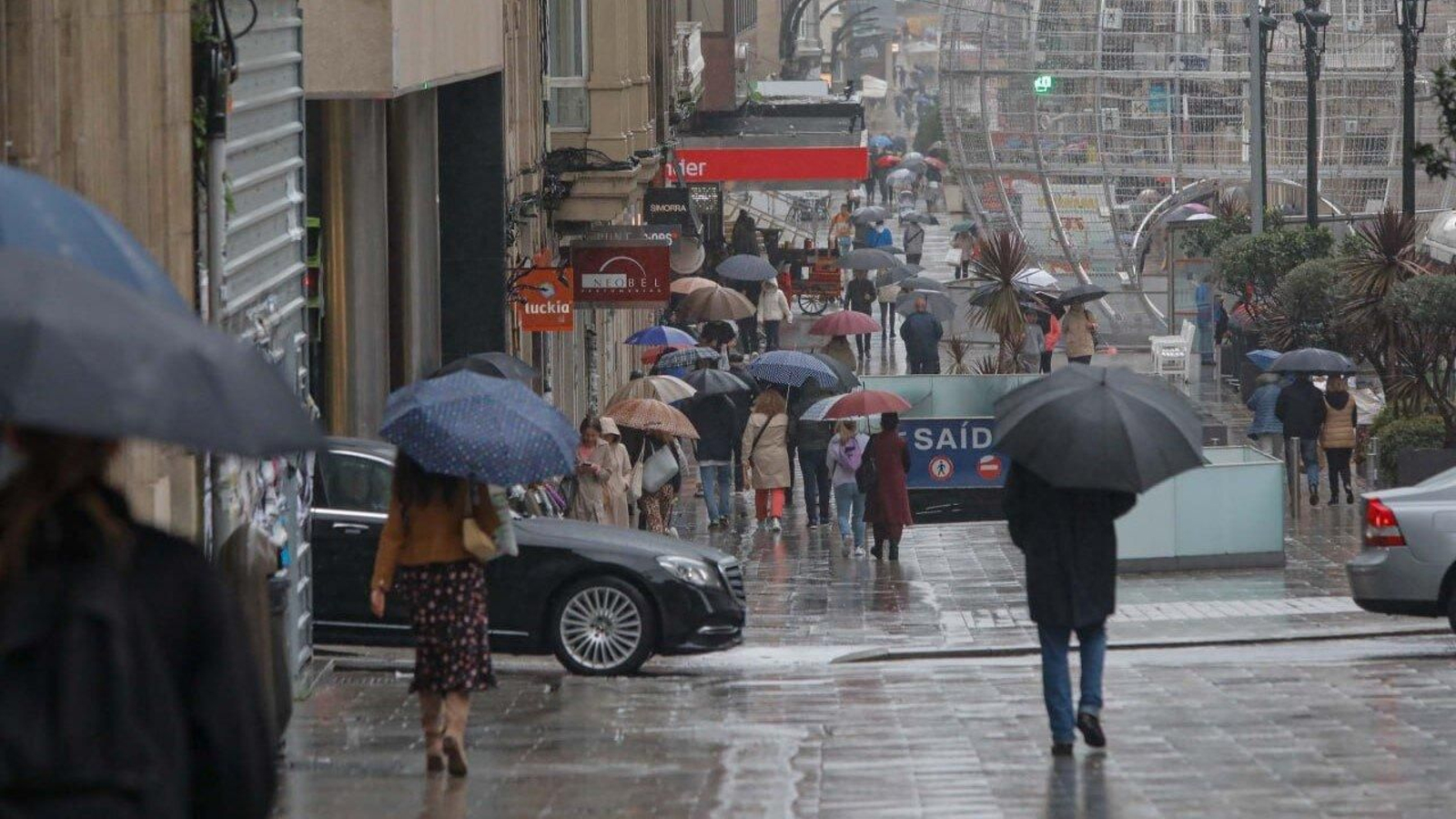 Varias personas caminan bajo la lluvia por Vigo. // Jorge Santomé