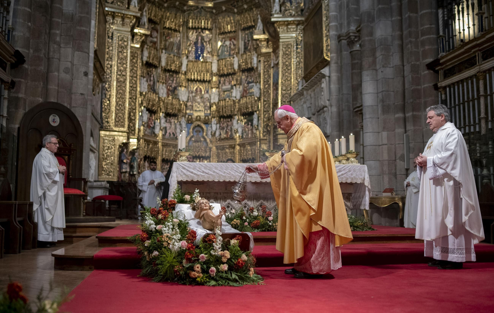 El obispo bendice al Niño Jesús durante la Misa de Reyes.