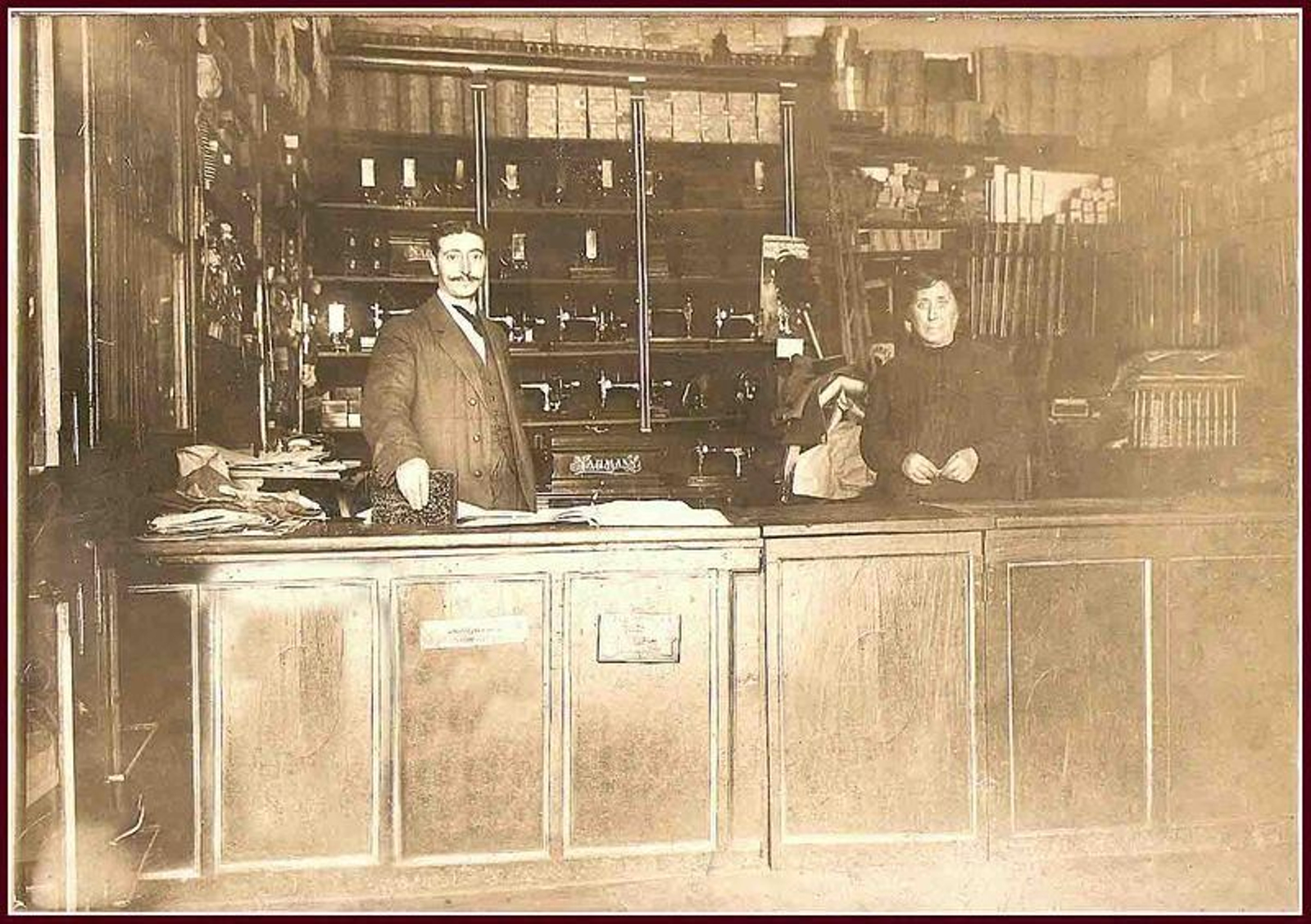 Armería de don Juan Calvo, Praza Maior, 22 (hoy Trampitan). Detrás del mostrador posan doña Protasia Moraza Berroeta, viuda del fundador, Juan Calvo, y el encargado, Leonardo Pascual. Fotografía: Archivo Conchita Calvo.