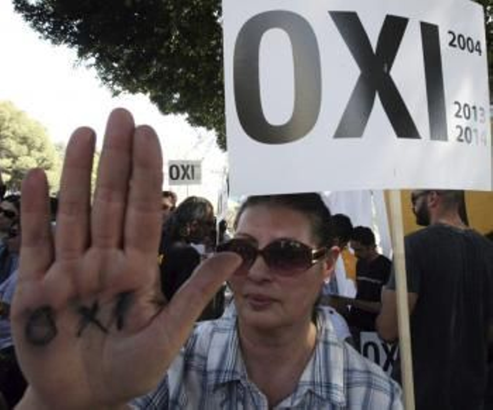Una mujer yemení muestra en su mano y en una pancarta la palabra 'no' durante un acto de protesta contra el plan de ajuste acordado con la troika (Foto: EFE)