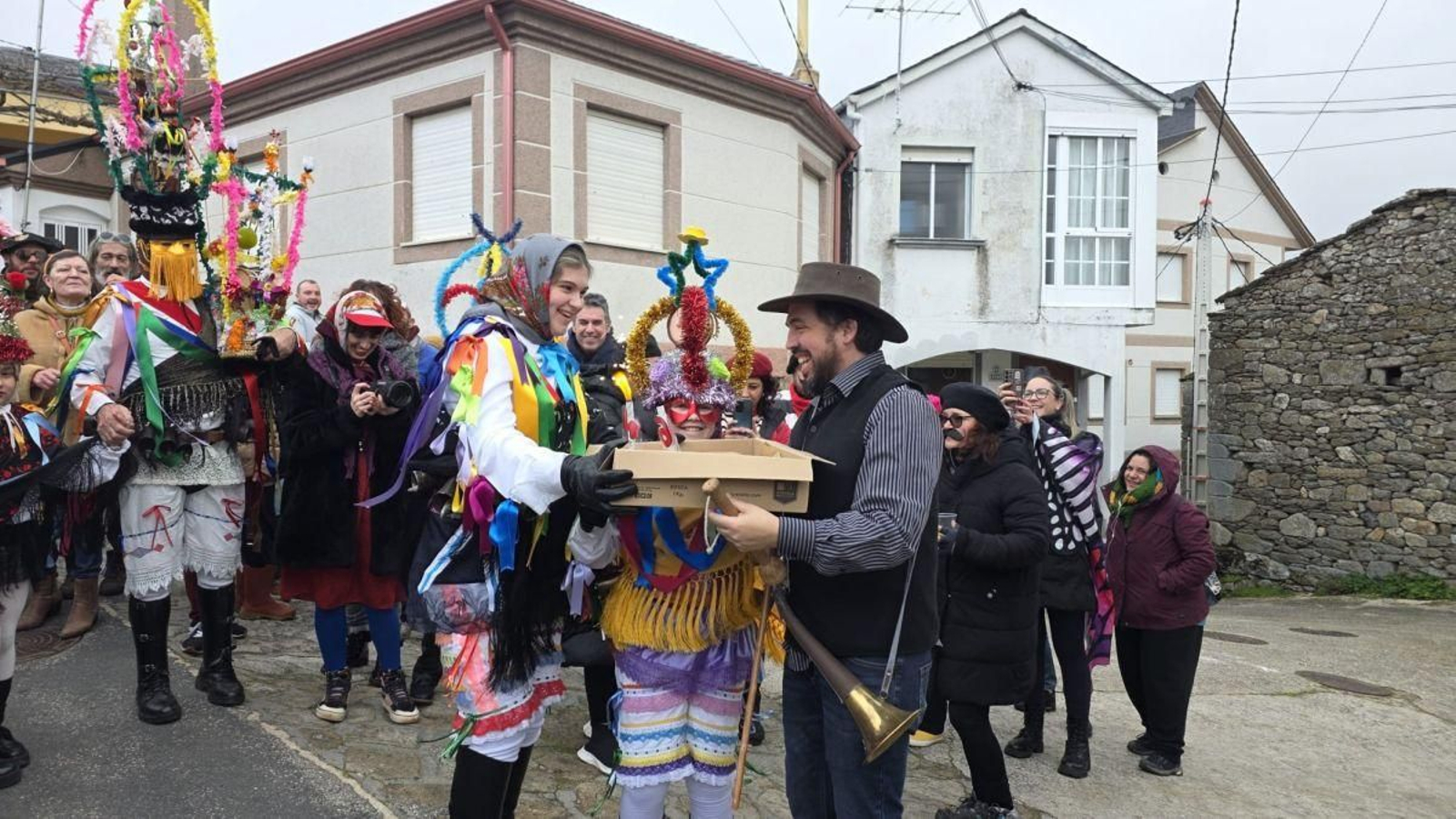Carlos Álvarez soplando las velas en la tarta que sus hijas vestidas de mázcara le acercaban, con todo el fulión cantando al son de la gaita.