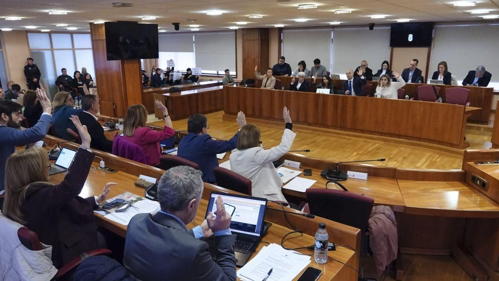 Los concejales socialistas alzando su mano ayer durante una votación en el pleno.