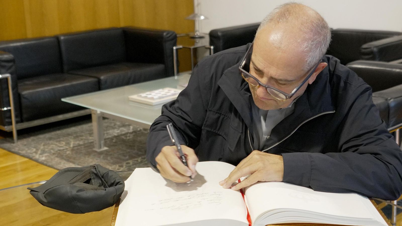 El alcalde de Ginebra durante la firma en el libro de Honor