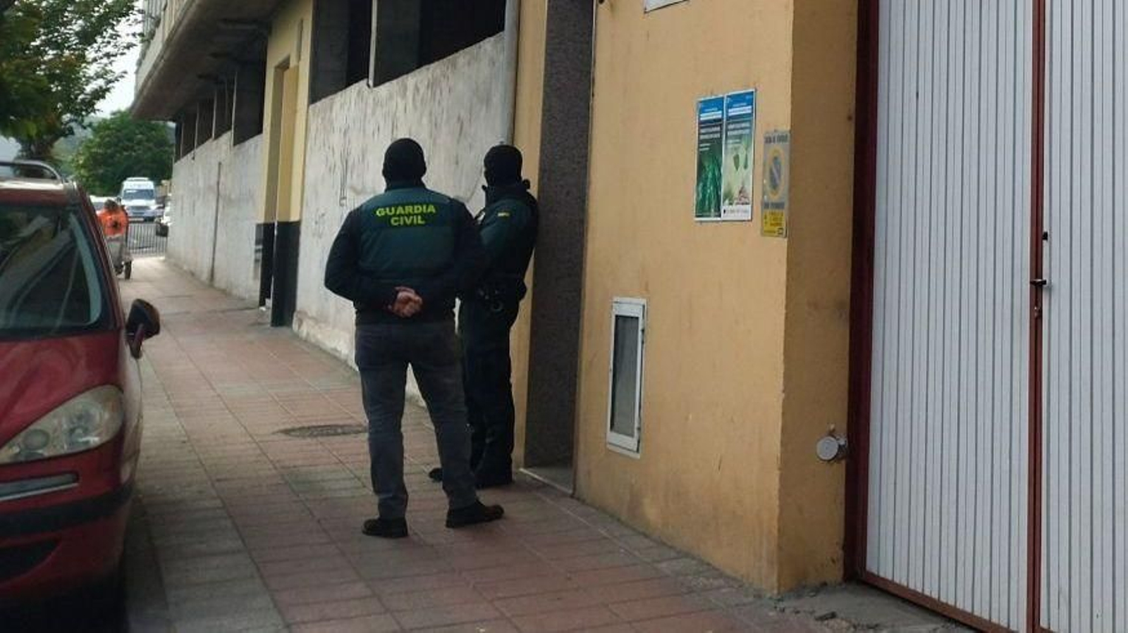 Dos agentes, colocados a la entrada de un edificio de Ramón y Cajal.