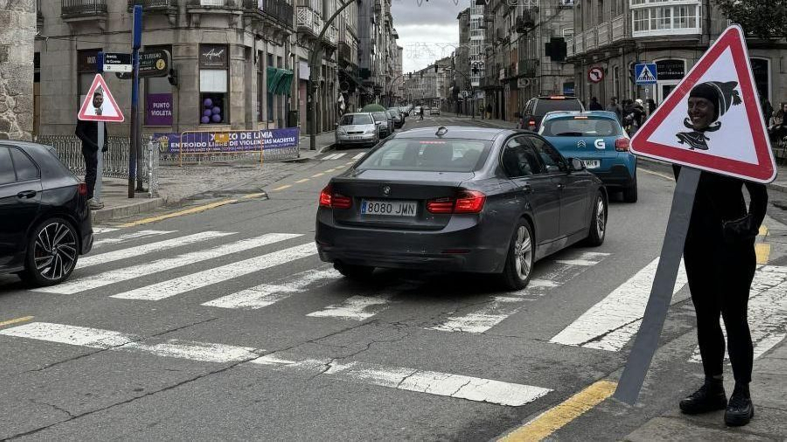 Limianos disfrazados de señal regulando el tráfico.
