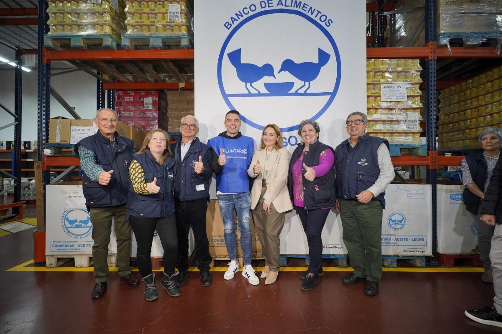 Iván Martínez, Iago Aspas y Marián Mouriño, con voluntarios del Banco de Alimentos en la nave de Lavadores.