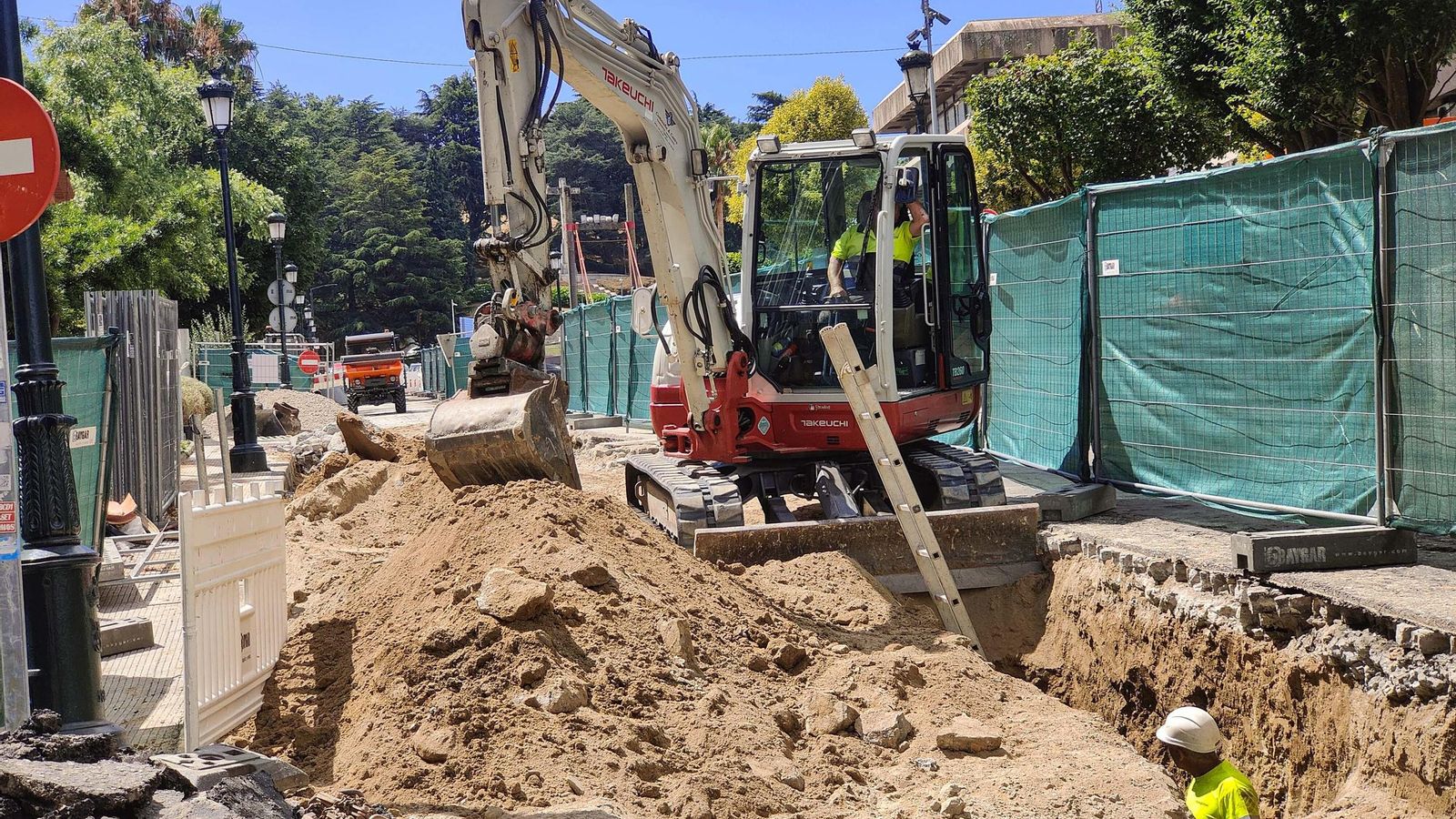 Operarios y maquinaria trabajando en el Paseo de Granada.