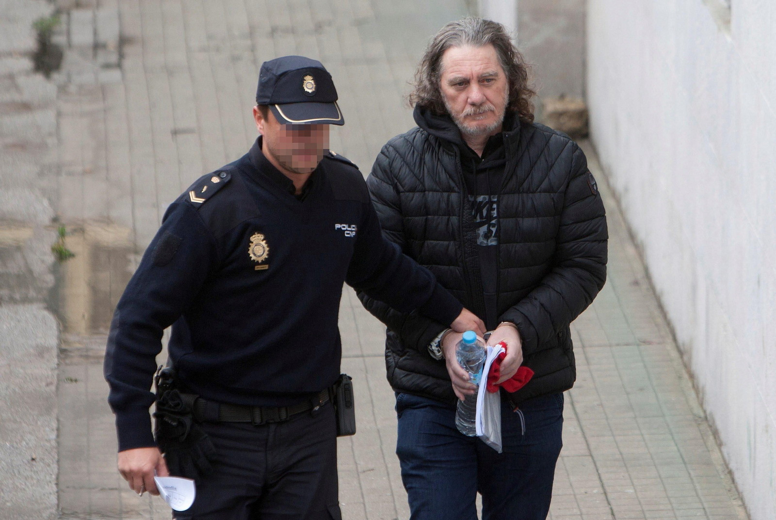 Un agente conduce a Sito Miñanco a su llegada a la Audiencia de Pontevedra.