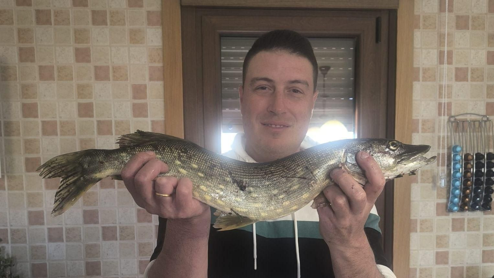 David Rodríguez "Fano", sosteniendo el ejemplar de lucio pescado