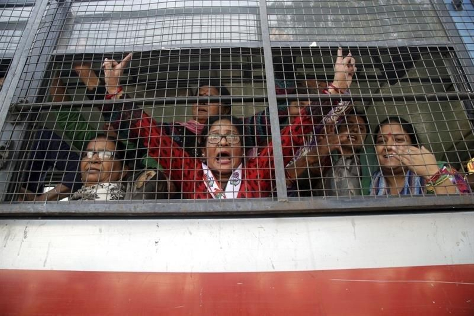 Trabajadores del Partido del Congreso corean consignas dentro de un furgón tras ser arrestados por la policía durante una manifestación contra la repentina retirada de los billetes de mayor denominación en rupias el pasado 8 de noviembre, en Jamm