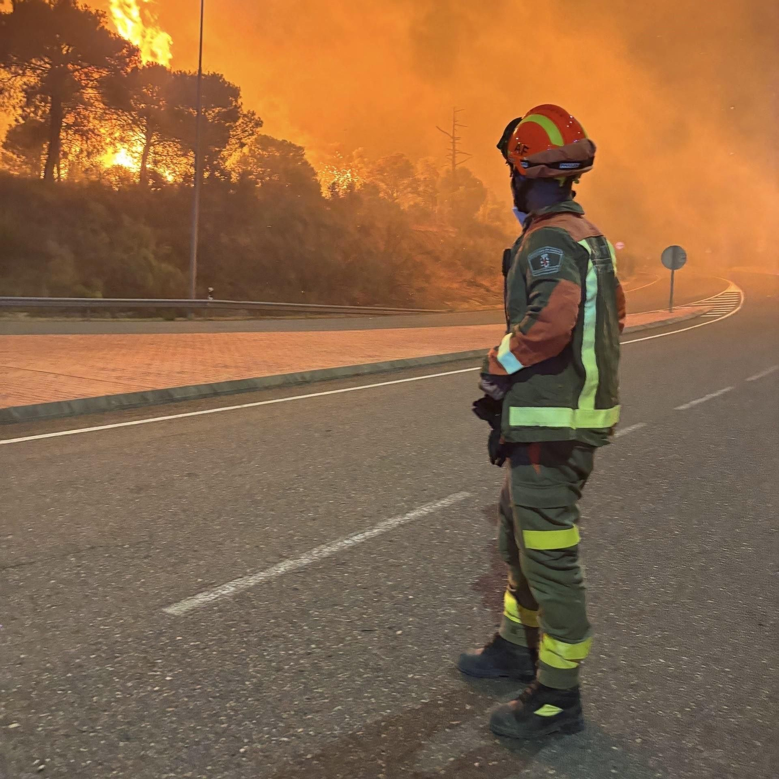 Un bombero observa las llamas a poca distancia del incendio