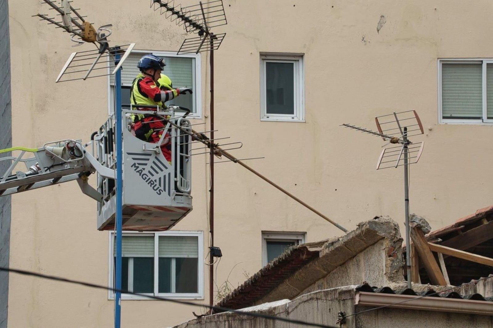 Un bombero comprueba el estado de la vivienda tras caer una pared.